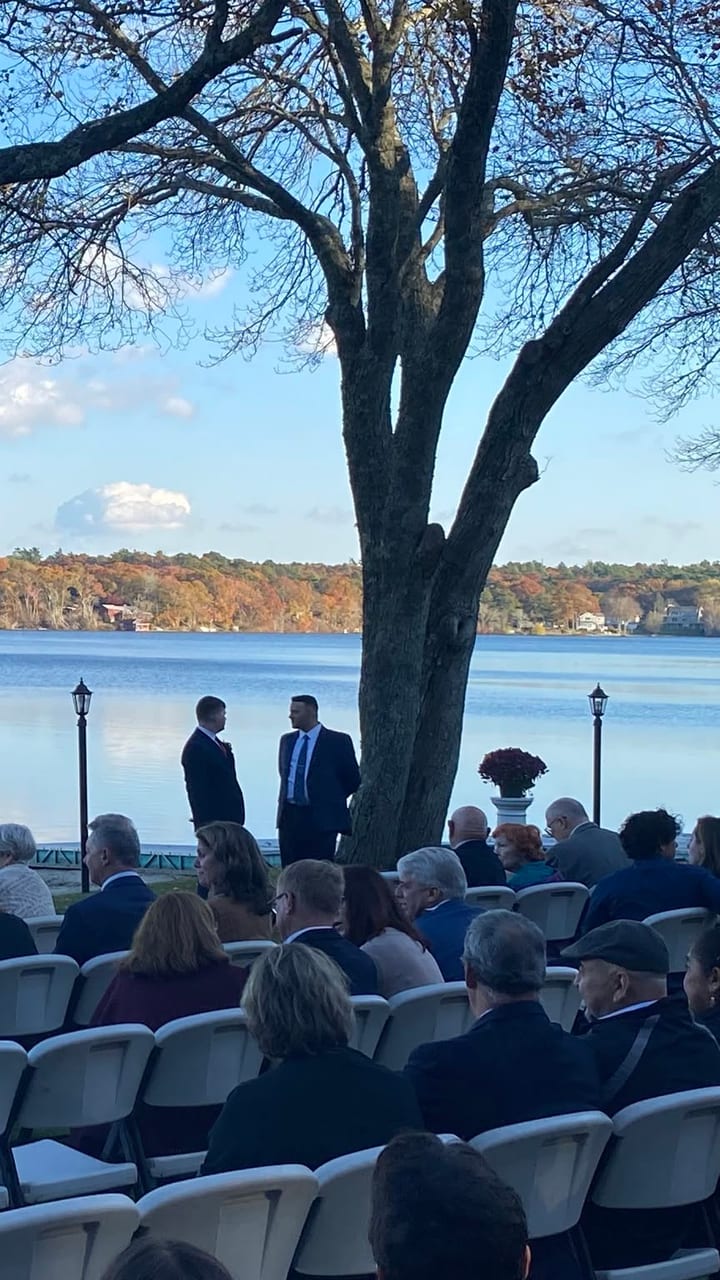 The ceremony arch set up on the water before guests are seated