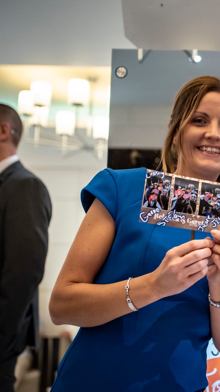 A guest holding the strip she just printed